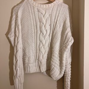 White cropped sweater with braid down the middle